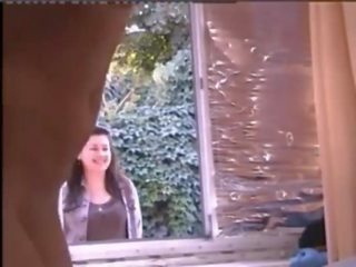 Young female naked in window while people pass hahaha